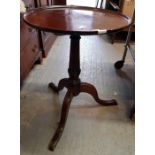 A 19th century circular mahogany table standing on