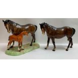 A Beswick group of a mare and foal standing on gra