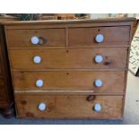 A Victorian pine chest of drawers, with white cera