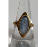 A 9 carat gold ring set with a pale blue synthetic