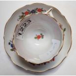 A Meissen coffee cup and saucer, decorated with bu