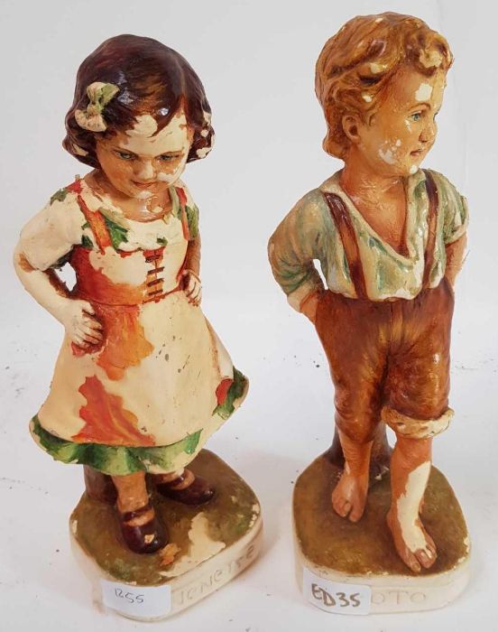 A pair of chalk ware figures of a boy and girl, 28