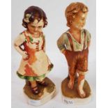 A pair of chalk ware figures of a boy and girl, 28