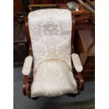 A Victorian mahogany framed armchair, upholstered