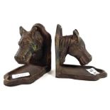 A pair of cast metal bookends, in the form of hors