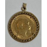 A 1908 half sovereign in a gold pendant mount