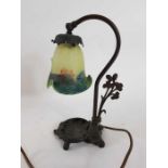 A 20th century Art Nouveau lamp with a glass shade