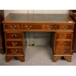 A 20th century mahogany pedestal desk, with a leat