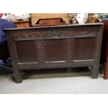 A 18th century oak coffer, with carved front secti