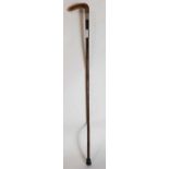 A bamboo walking cane with horn handle and silver