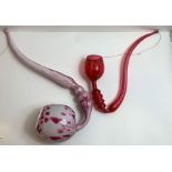 A Victorian glass red and white pipe, along with a