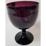 A large amethyst glass goblet on domed circular fo