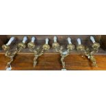 A set of four 20th century brass wall lights, decorated with fl