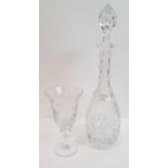 A tall etched and cut glass decanter with tall sto