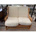 Wicker settee with cream coloured cushions, condit