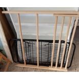 2 black metal racks along with a wooden pine rack,