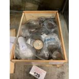 Cigar box filled with various coins from over the