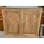A Victorian two door pine cupboard,