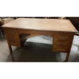 A 20th century oak desk, set with one long drawer
