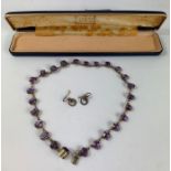 A vintage purple paste stone necklace, and a pair