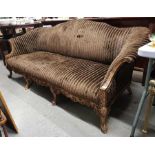 A walnut framed Victorian sofa, with scroll ends,