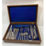 A silver plated canteen of cutlery in an oak case