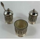 A Middle Eastern white metal cruet set, profusely