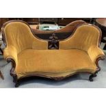 A Victorian mahogany framed double spoon back sofa