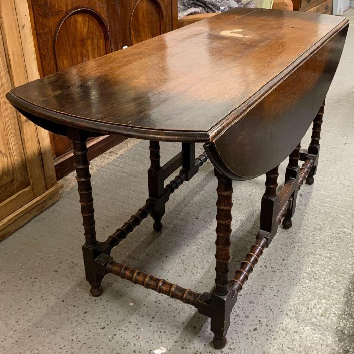 A 20th century stained oak gate leg wake table with two drop le