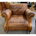 A modern leather open club style armchair, on maho