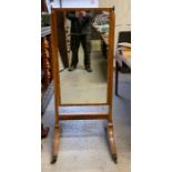 A Victorian mahogany cheval mirror, standing on ou