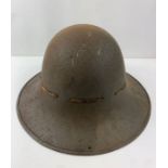 A British WWII tin hat, with internal webbing, ind