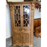 Decorative pine corner cupboard with glazed top section