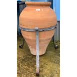 Large terracotta olive pot in metal stand