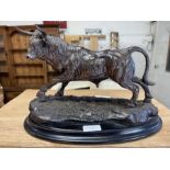 A resin model of a bull, standing on oval base