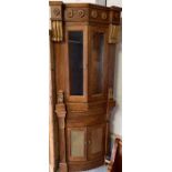 Oak corner cupboard with decorative gilt corbels a