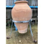 Large terracotta olive pot in metal stand