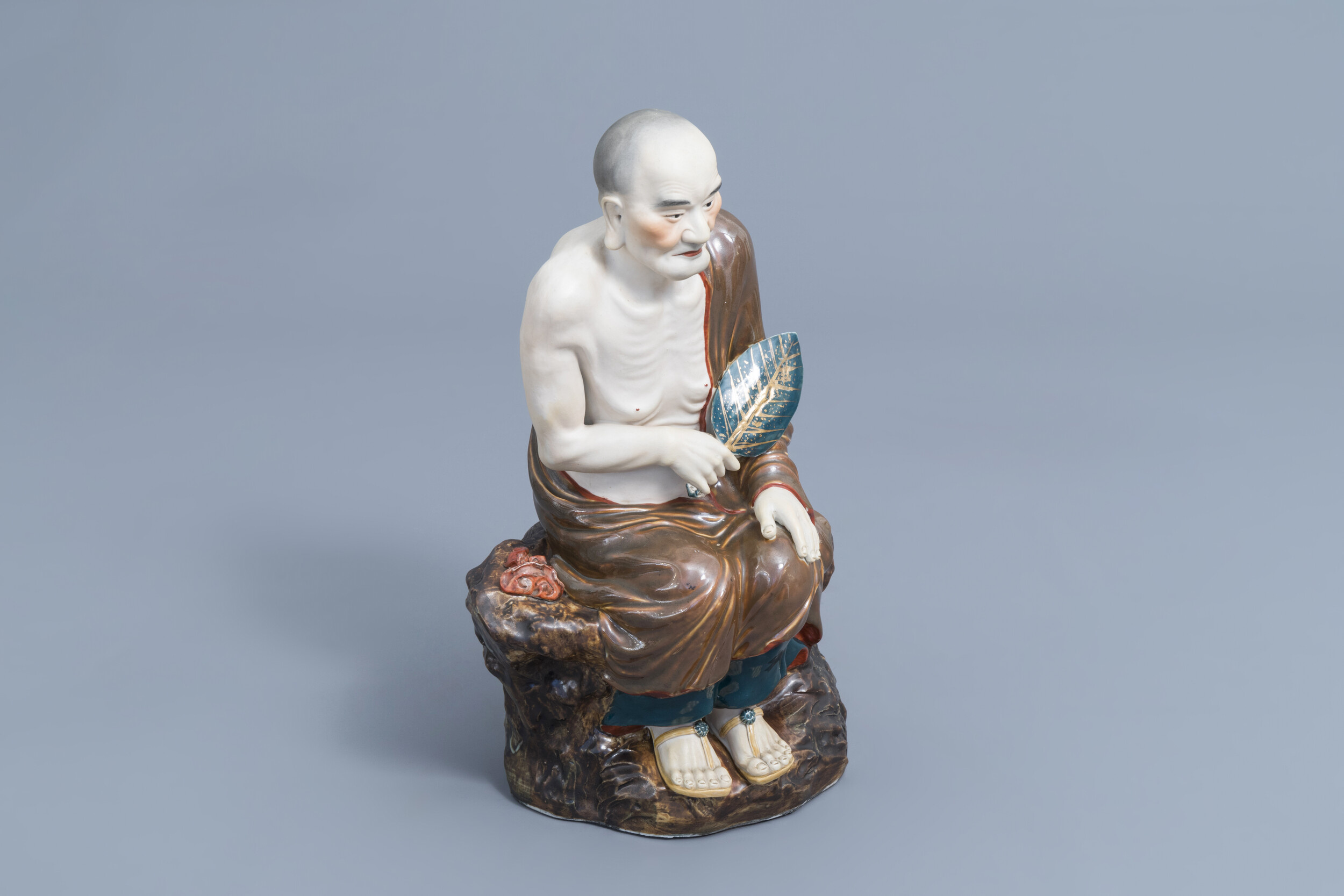 A Chinese Luohan figure in polychrome porcelain and biscuit, 20th C.