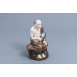 A Chinese Luohan figure in polychrome porcelain and biscuit, 20th C.