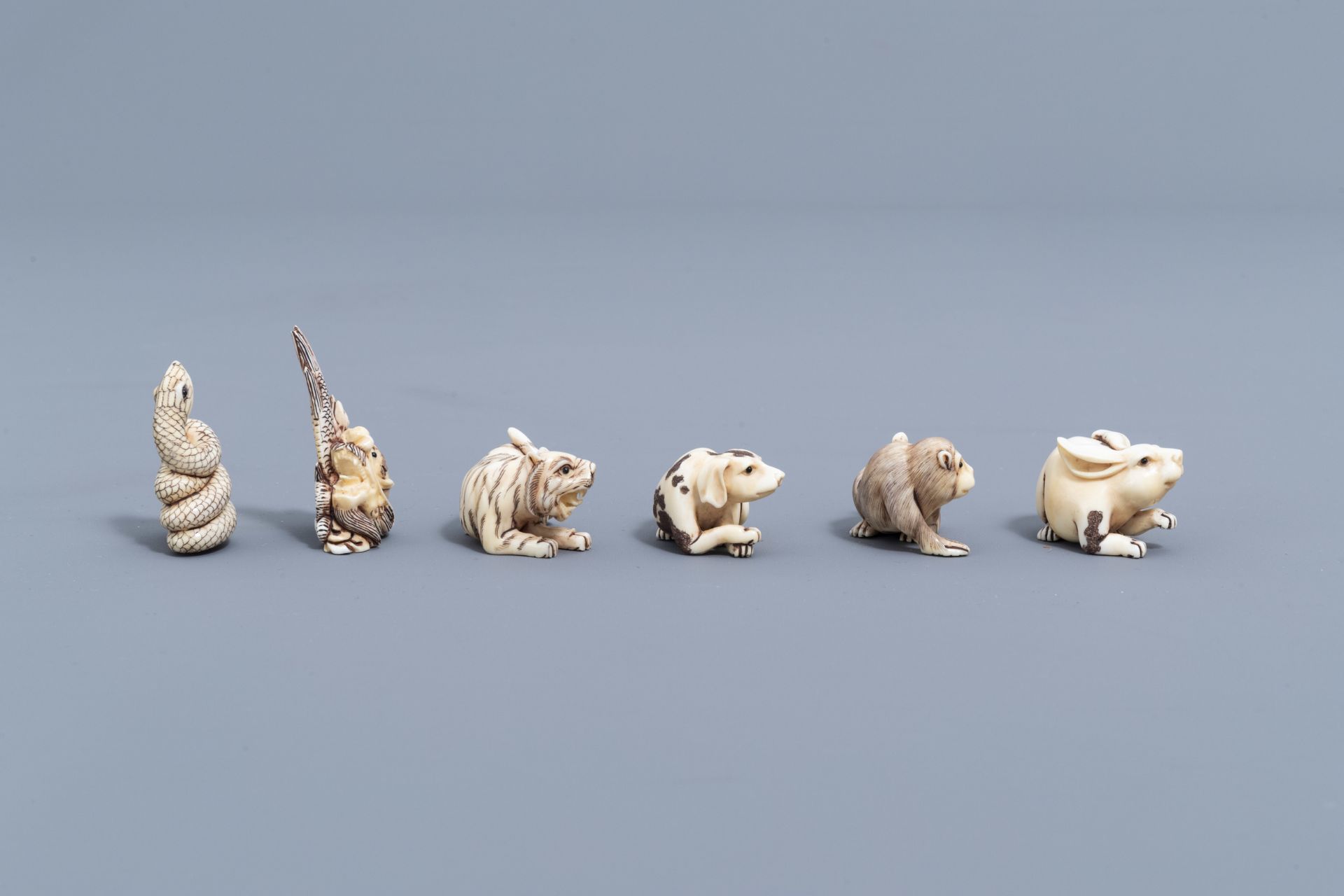 Twelve Japanese animal shaped netsuke in their display cabinet, first half of the 20th C. - Image 4 of 27