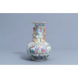A Chinese Canton famille rose bottle vase with relief design, 19th C.