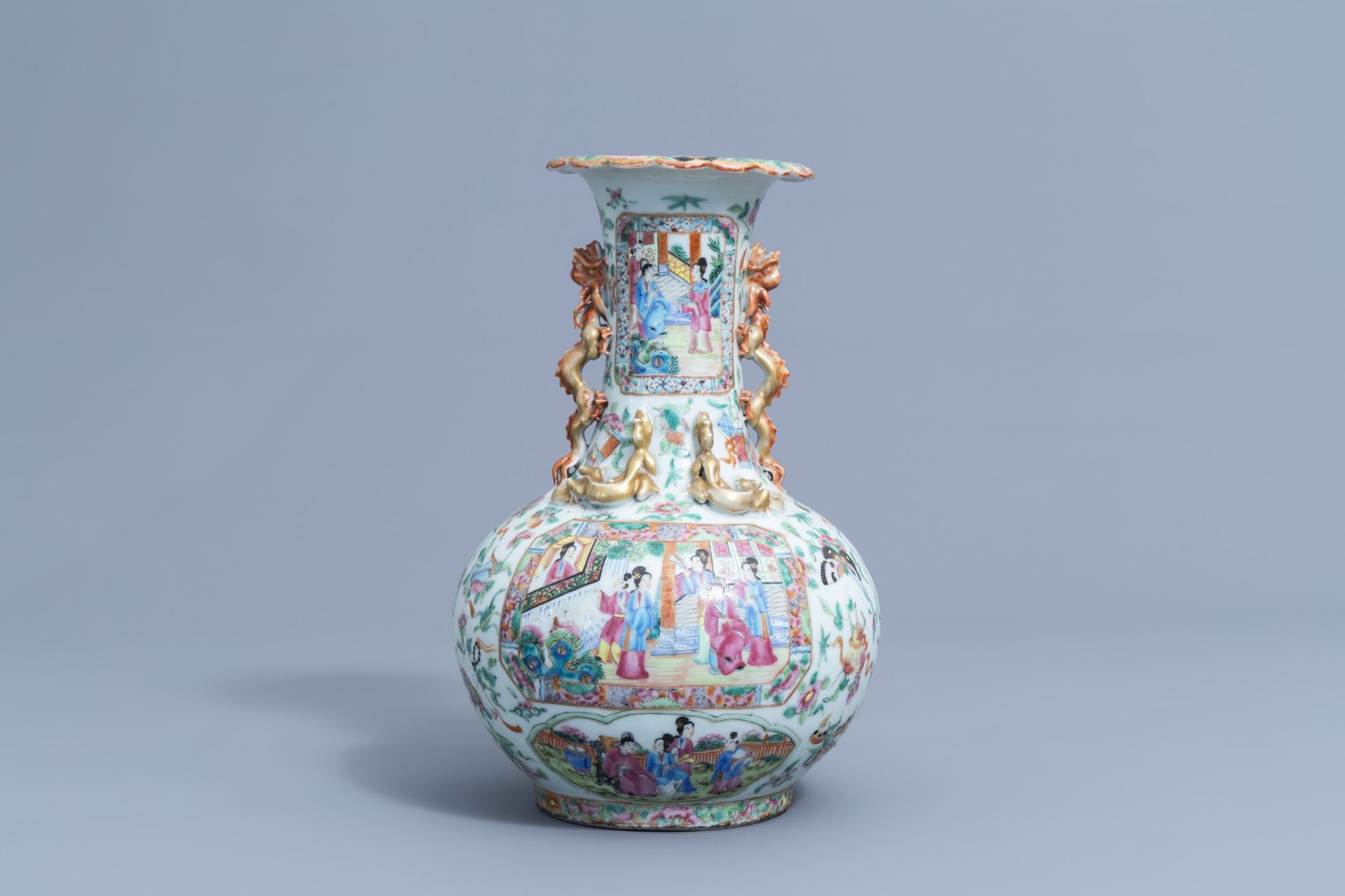 A Chinese Canton famille rose bottle vase with relief design, 19th C.