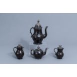 A silver mounted black glazed Namur pottery coffee pot, a teapot and two milk jugs, 18th C.