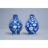 A pair of Chinese blue and white 'prunus on cracked ice' moonflask vases, Kangxi mark, 19th C.