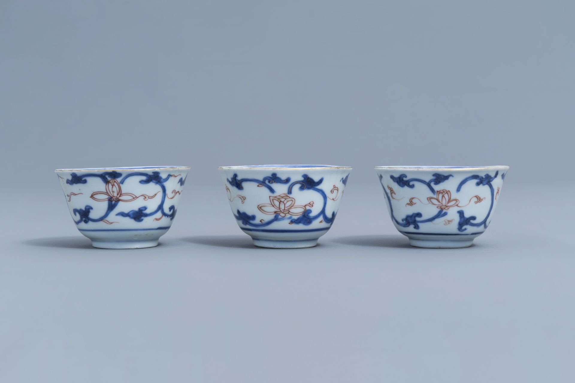 Six Chinese blue, white, iron red and gilt cups and saucers with floral design, Kangxi - Image 11 of 34