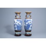 A pair of Chinese blue and white Nanking crackle glazed vases with peacocks, 19th C.