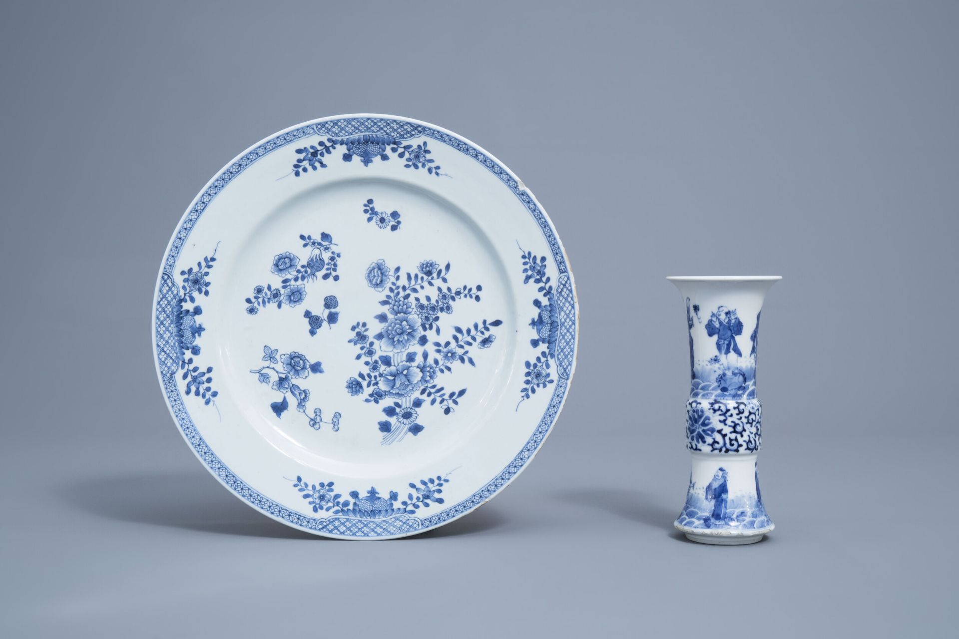 A Chinese blue and white charger and a gu 'Immortals' vase, Kangxi mark, 18th/19th C.