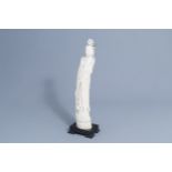 A large Chinese carved ivory figure of a lady on a wooden base, first half of the 20th C.