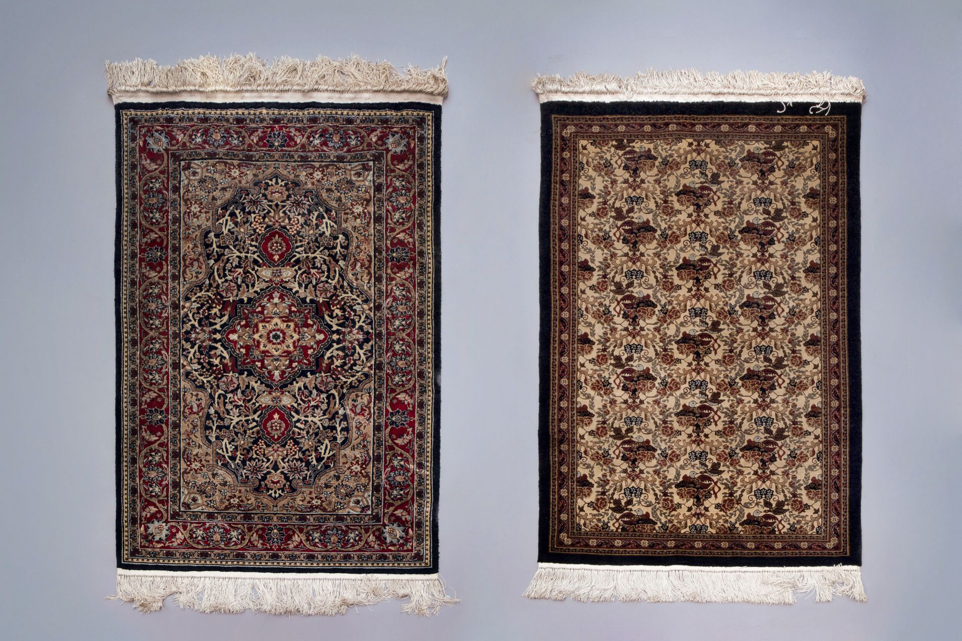 Two Oriental rugs with floral design, silk on cotton, 20th C.