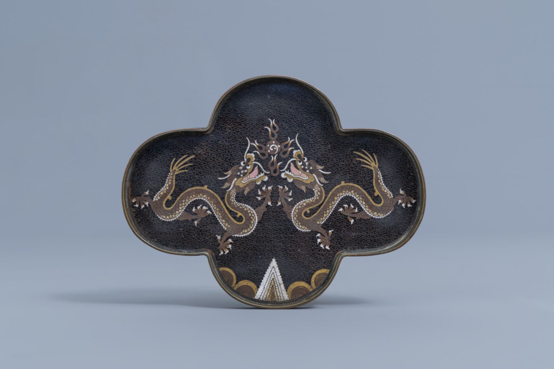 A Chinese quadrilobed cloisonnŽ opium tray with dragons chasing the pearl, 19th C.